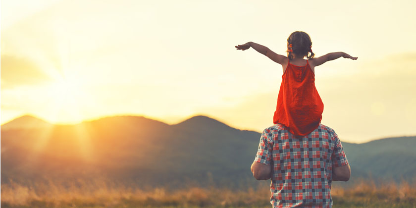 Young girl on her dad's shoulders
