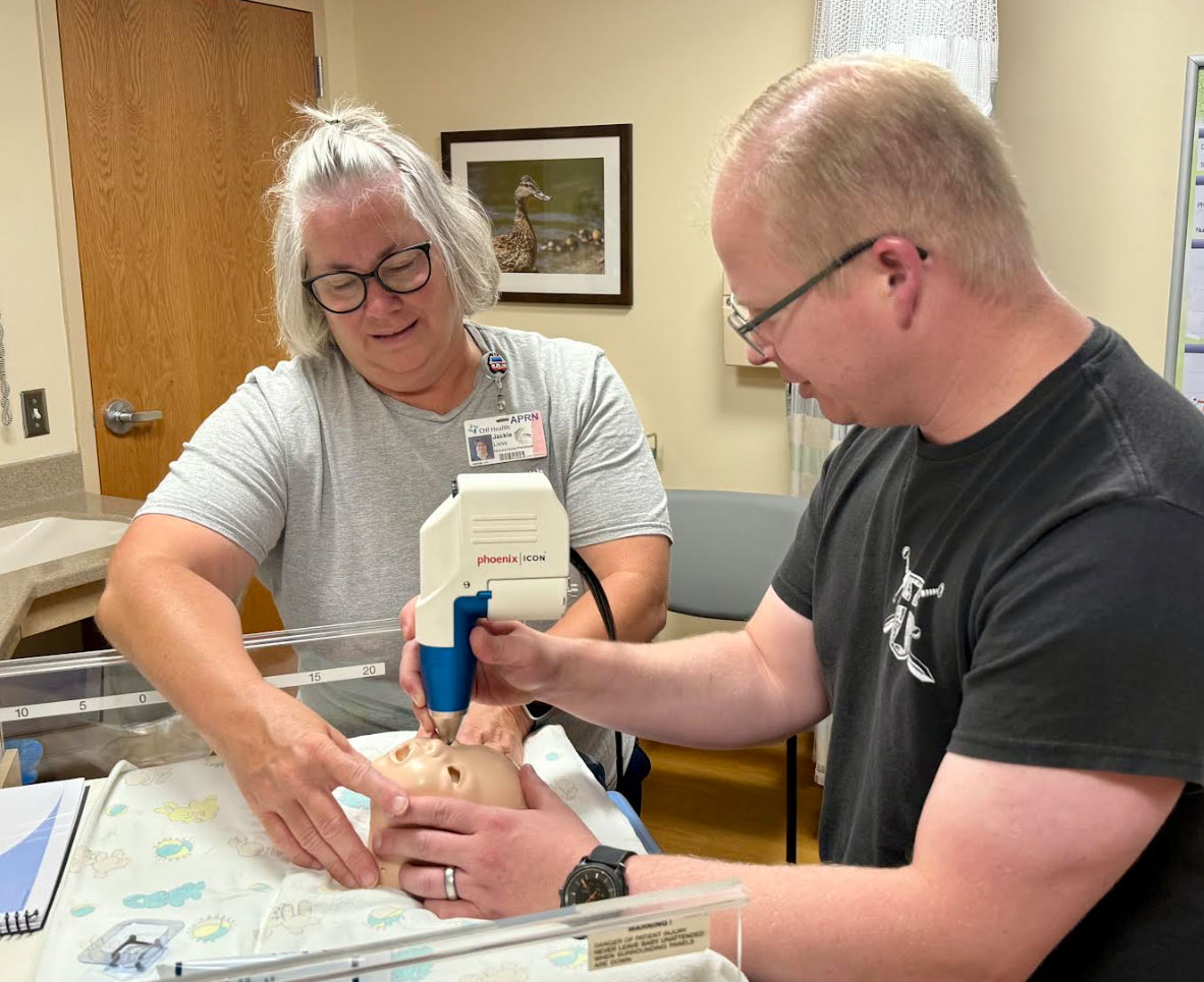 Jackie Leiss, neonatal nurse practitioner, and Dr. Evan Lackore, local pediatrician, train on CHI Health Good Samaritan's new retinal imaging system
