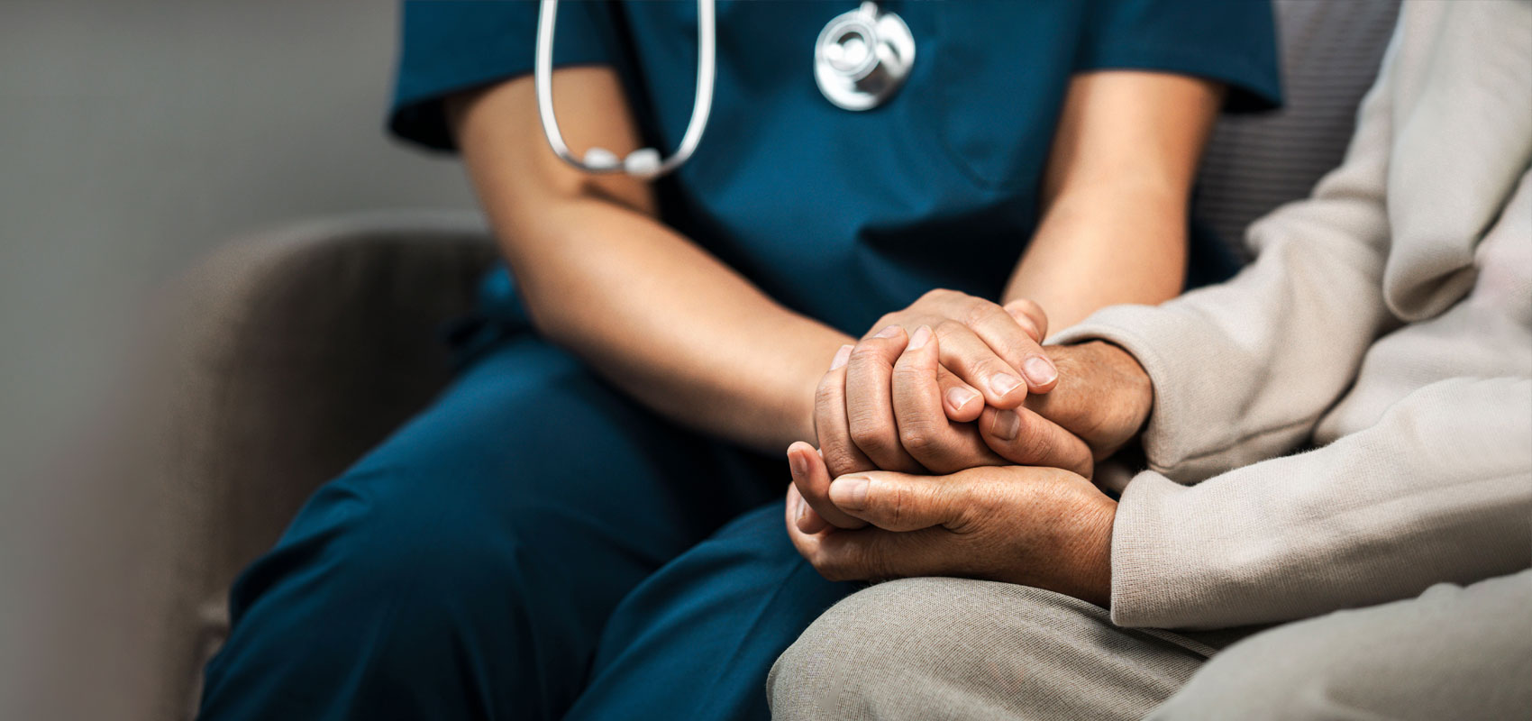 Medical provider holding the hand of a patient