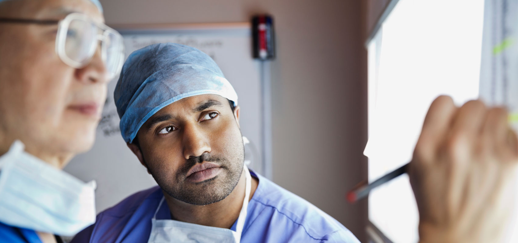 Two surgeons reviewing an x-ray