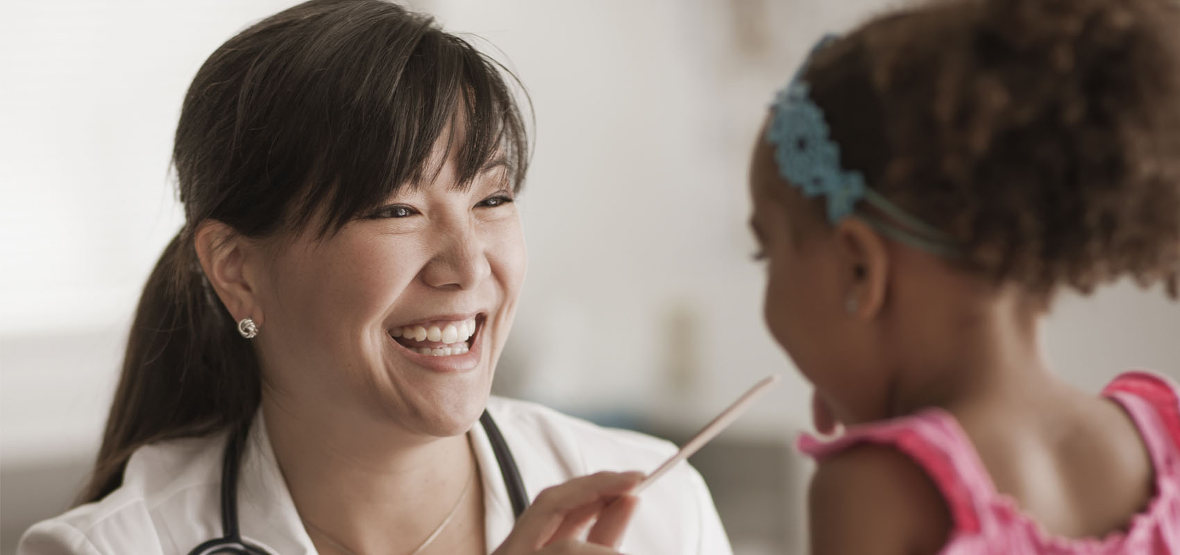 female pediatrician with young girl