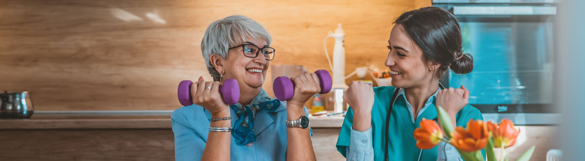 Senior and medical provider using hand weights
