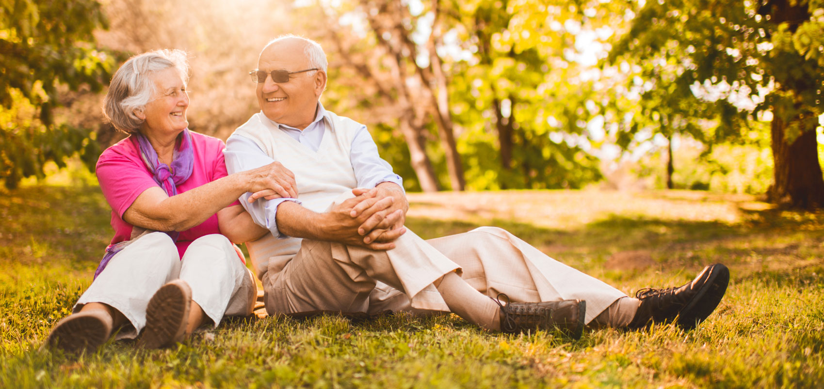 Senior couple on grass laughing