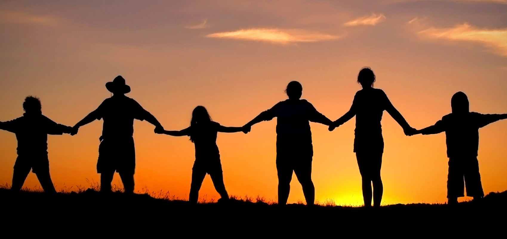 Silhouette of people holding hands