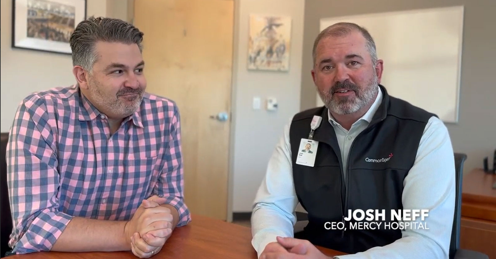 Outgoing CEO Brandon Mencici and incoming CEO Jeff Neff sit at a table together