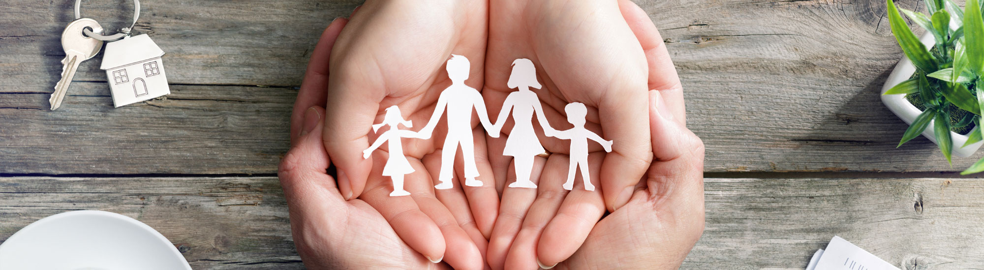 Paper cut out of family on a table
