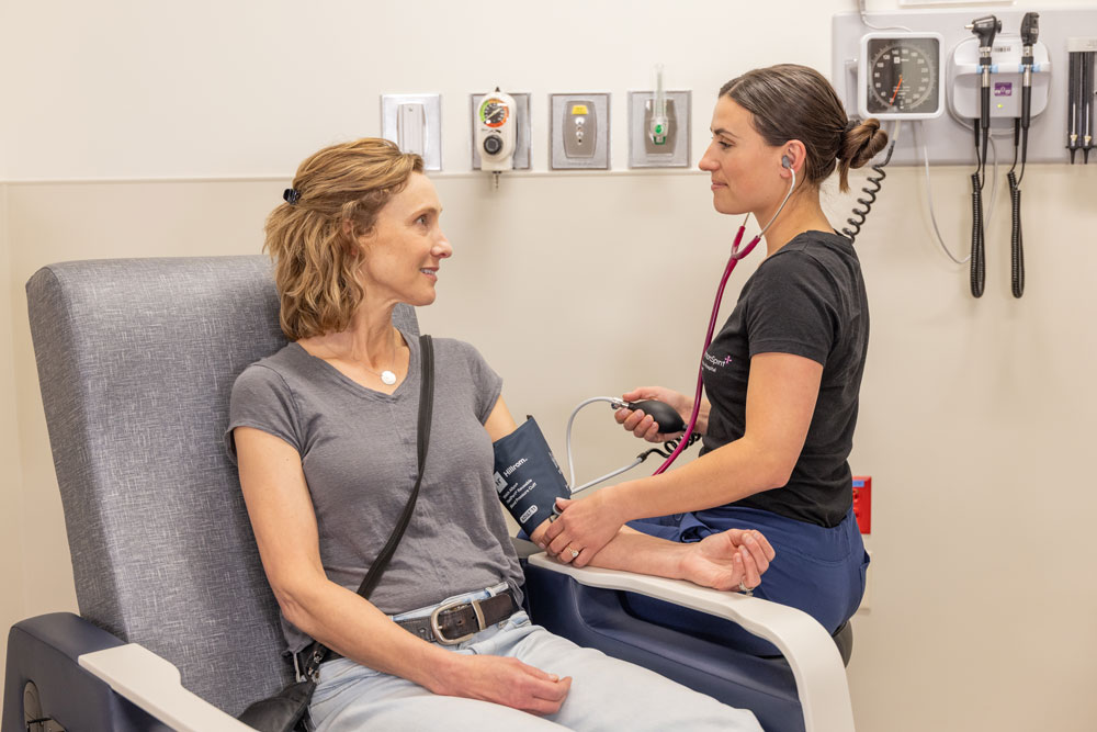 RN taking patients blood pressure