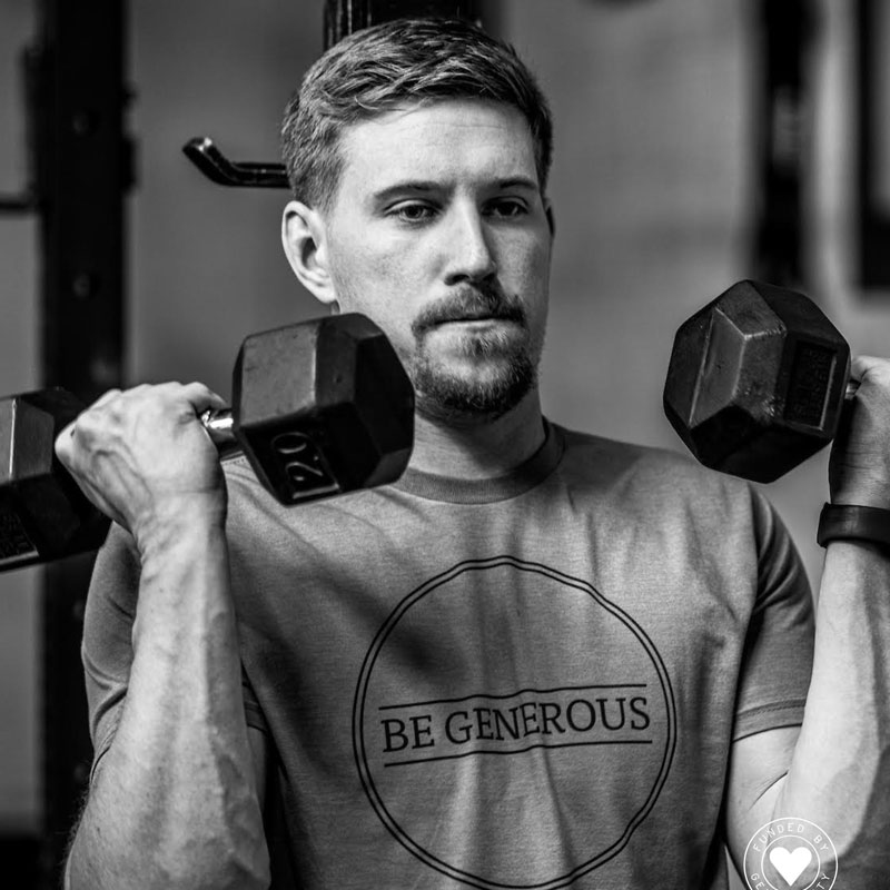 Portrait of Brandon Martz lifting dumbbells in a gym