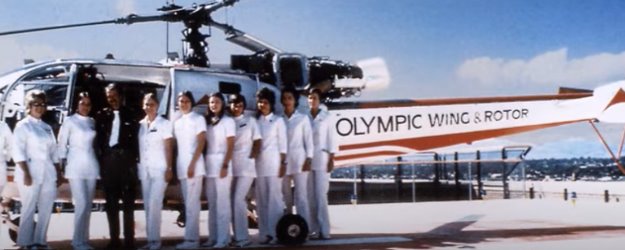 An early group photo of a medical unit posed in front of a helicopter circa 1972