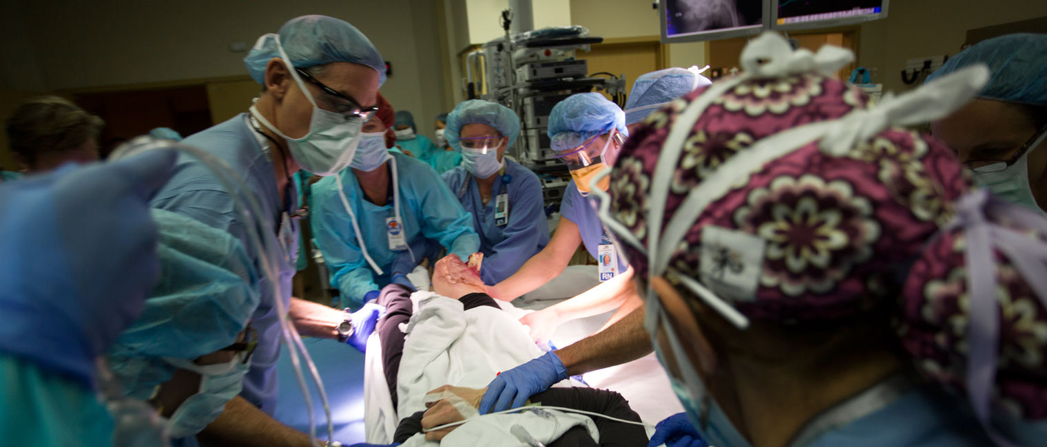 Doctors and nurses at work in a trauma operation room stabilize a patient