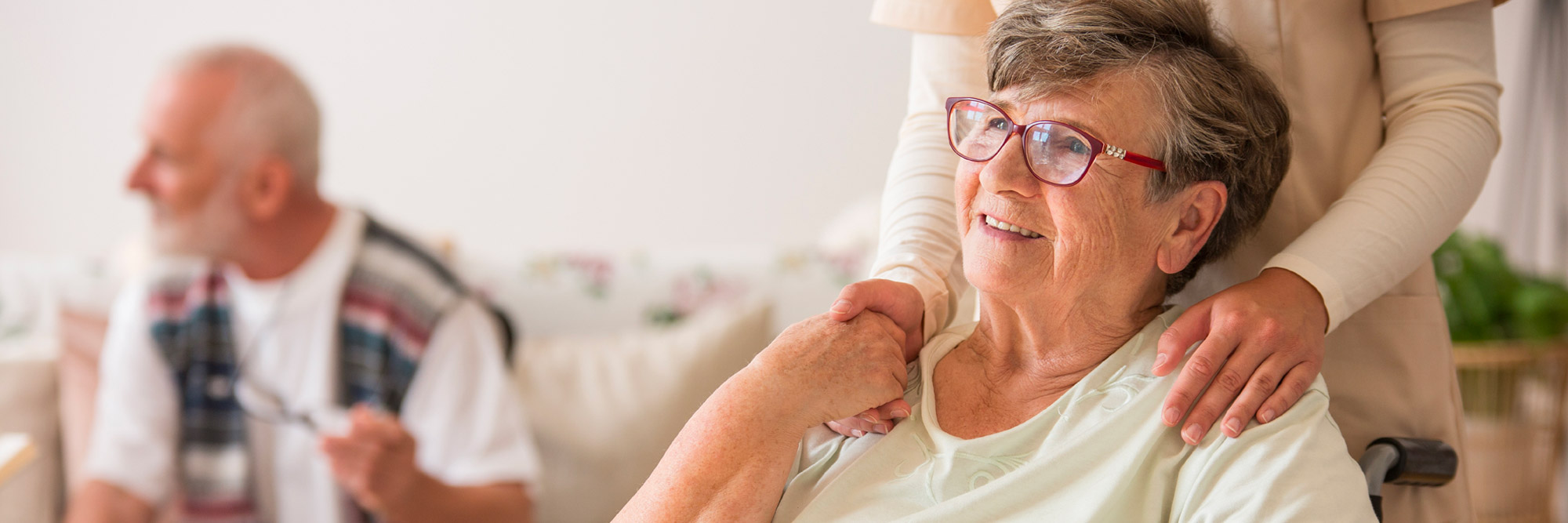 Senior woman smiling while sitting.