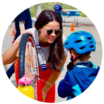 Woman showing bike safety tips to young boy