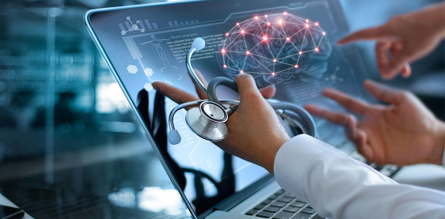 Medical providers pointing at laptop image of a brain scan model