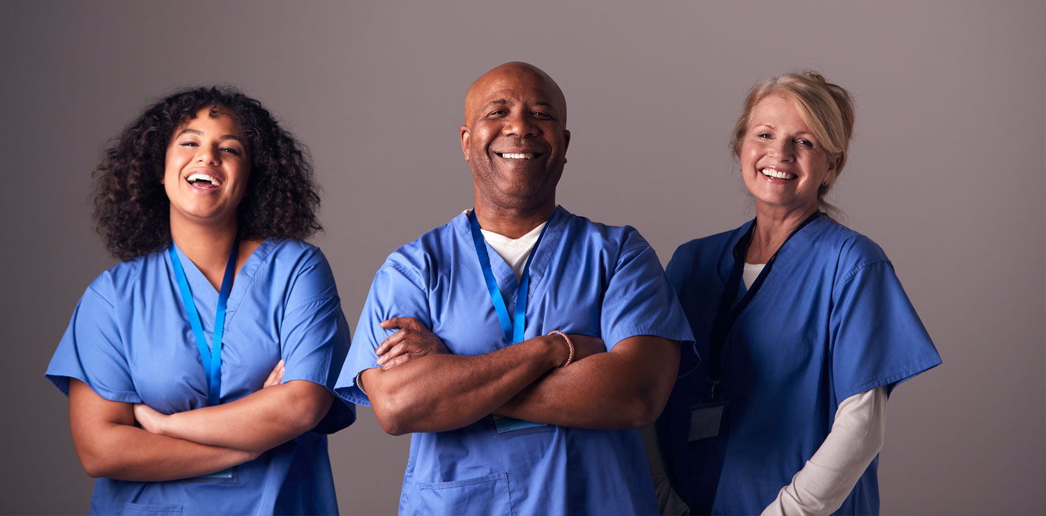 Three providers smiling and looking at camera