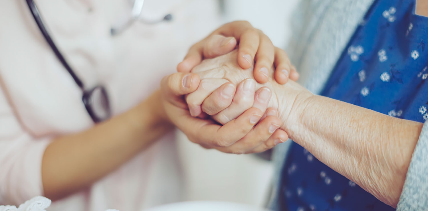 Provider hands holding patient hands