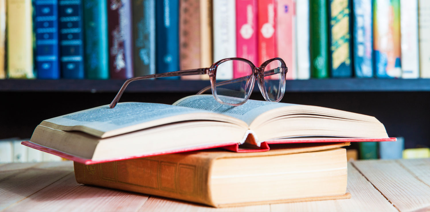 Glasses on top of a book in a library