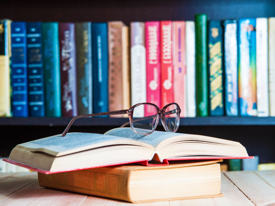 Reading glasses on top of an open book