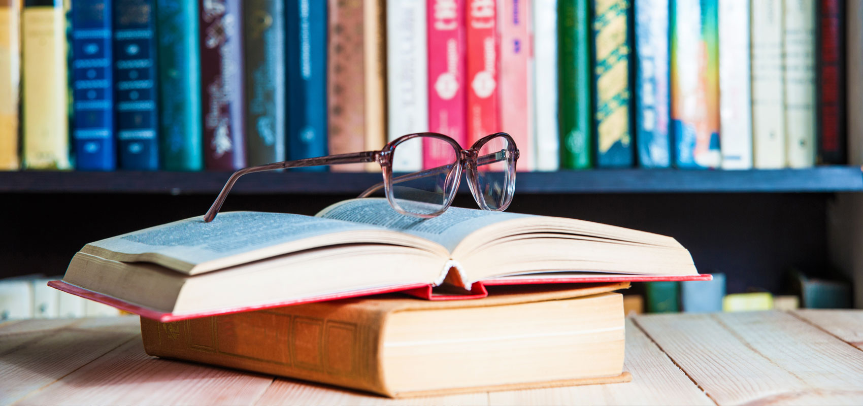 Glasses on top of a book in a library Glasses on top of a book in a library