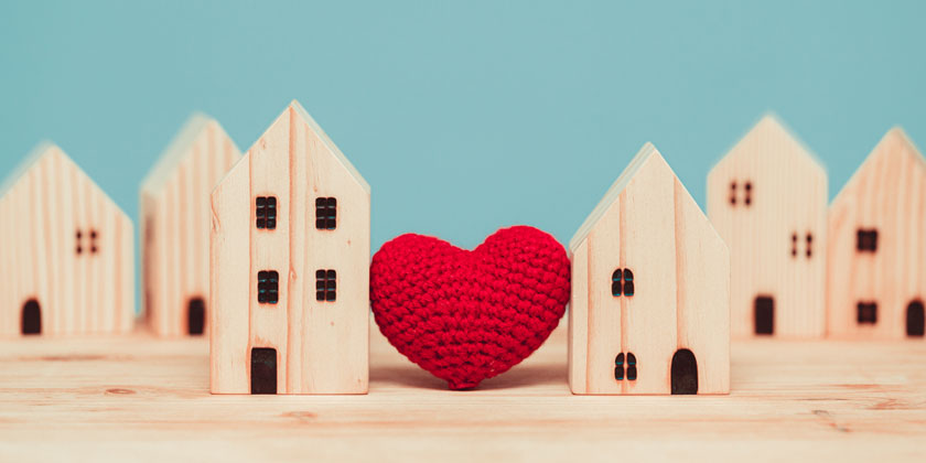 Heart between wooden houses