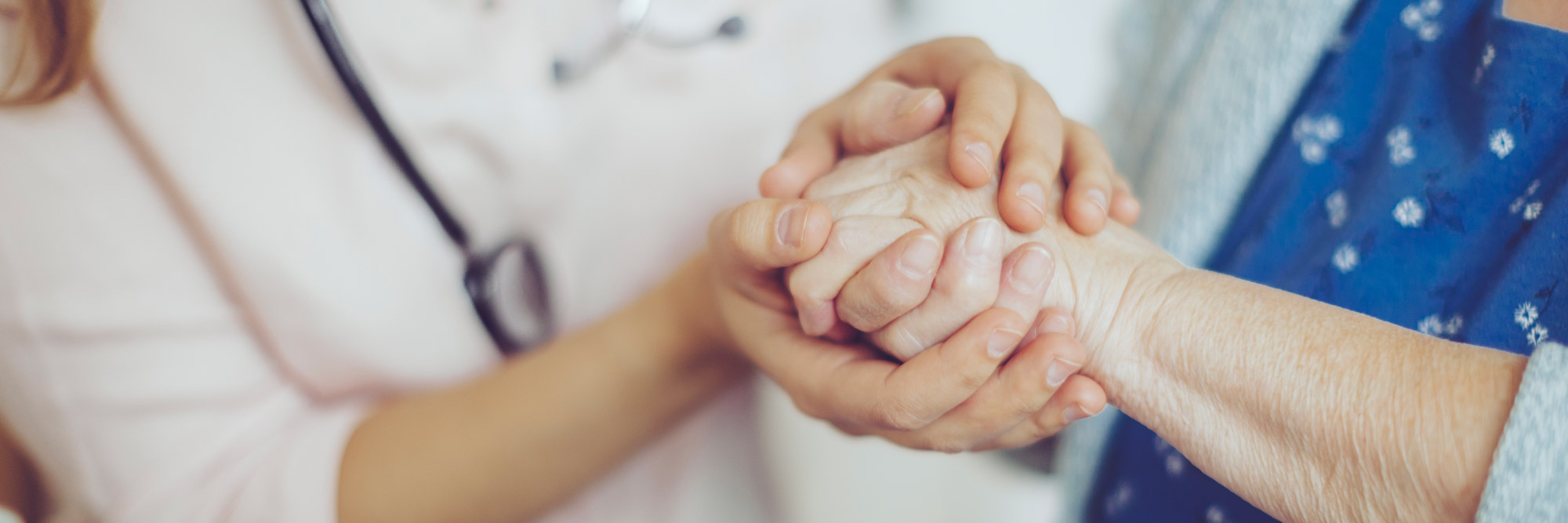 Provider holding hands with senior